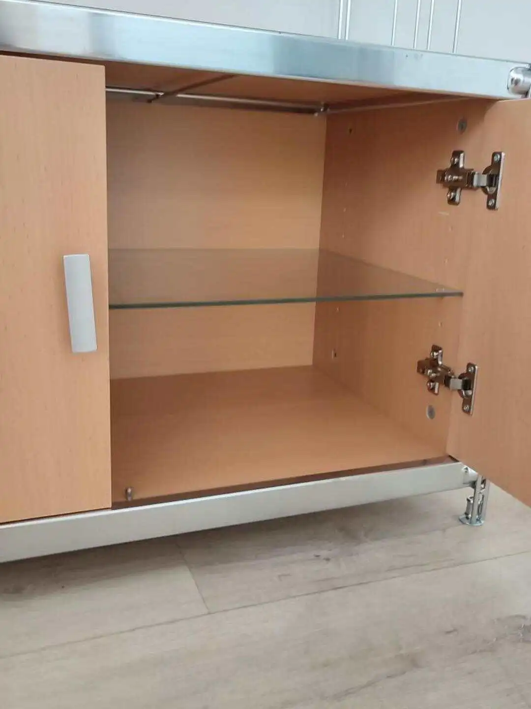 Hinter den Türen lassen sich Gegenstände charmant verbergen. Durch die Klarglas-Einlage-Platte (Sicherheitsglas mit geschliffenen Kanten), passend für Regalbreite 76 cm, wird der Stauraum noch größer!